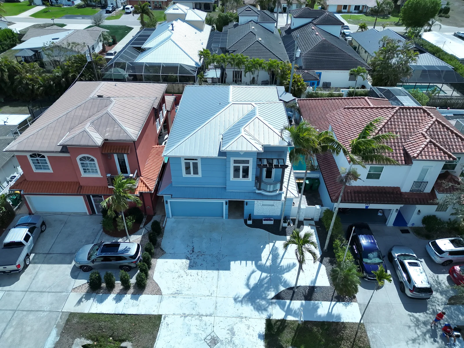 Elevated aerial view of homes, driveways, and landscaping