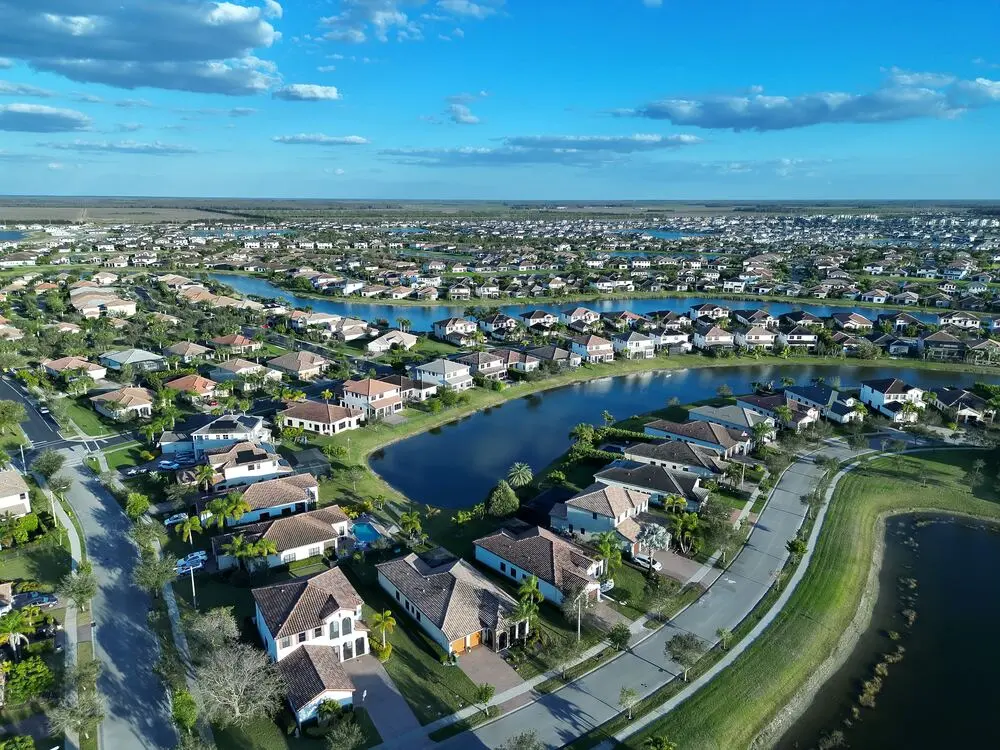 Aerial view of a Southwest Florida residential community with lakes and palm-lined streets
