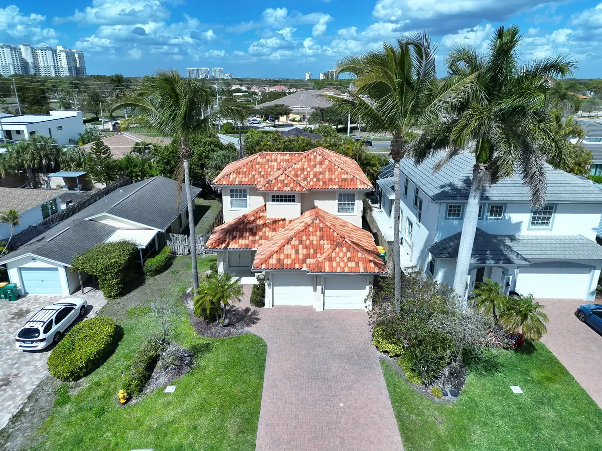 Aerial view of a residential home with tile roofing